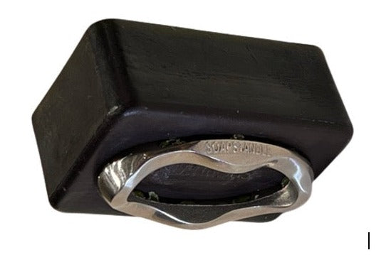 Image of a bar of soap securely attached to a sleek, stainless steel SoapStandle, demonstrating the stand's effective grip and modern design.